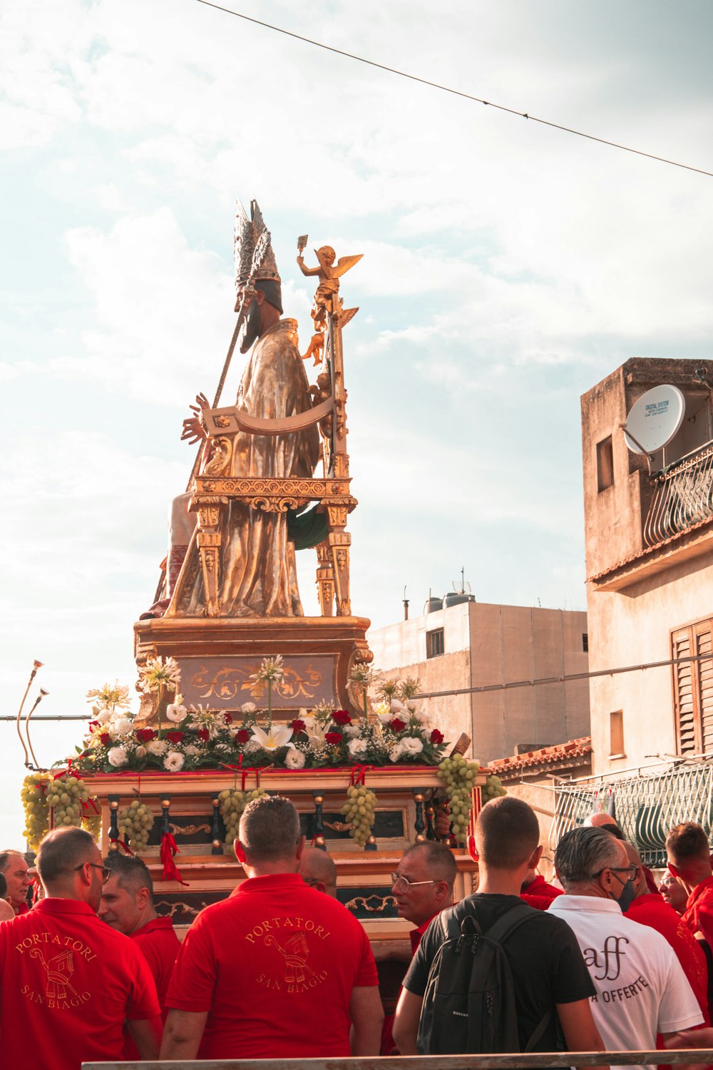 a group of people standing in front of a golden statue