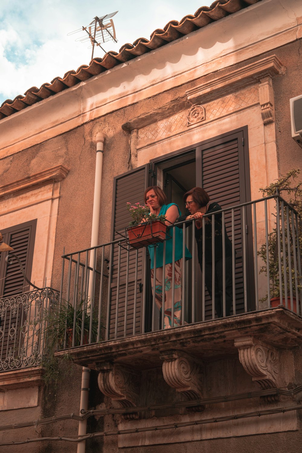 a couple of women on a balcony