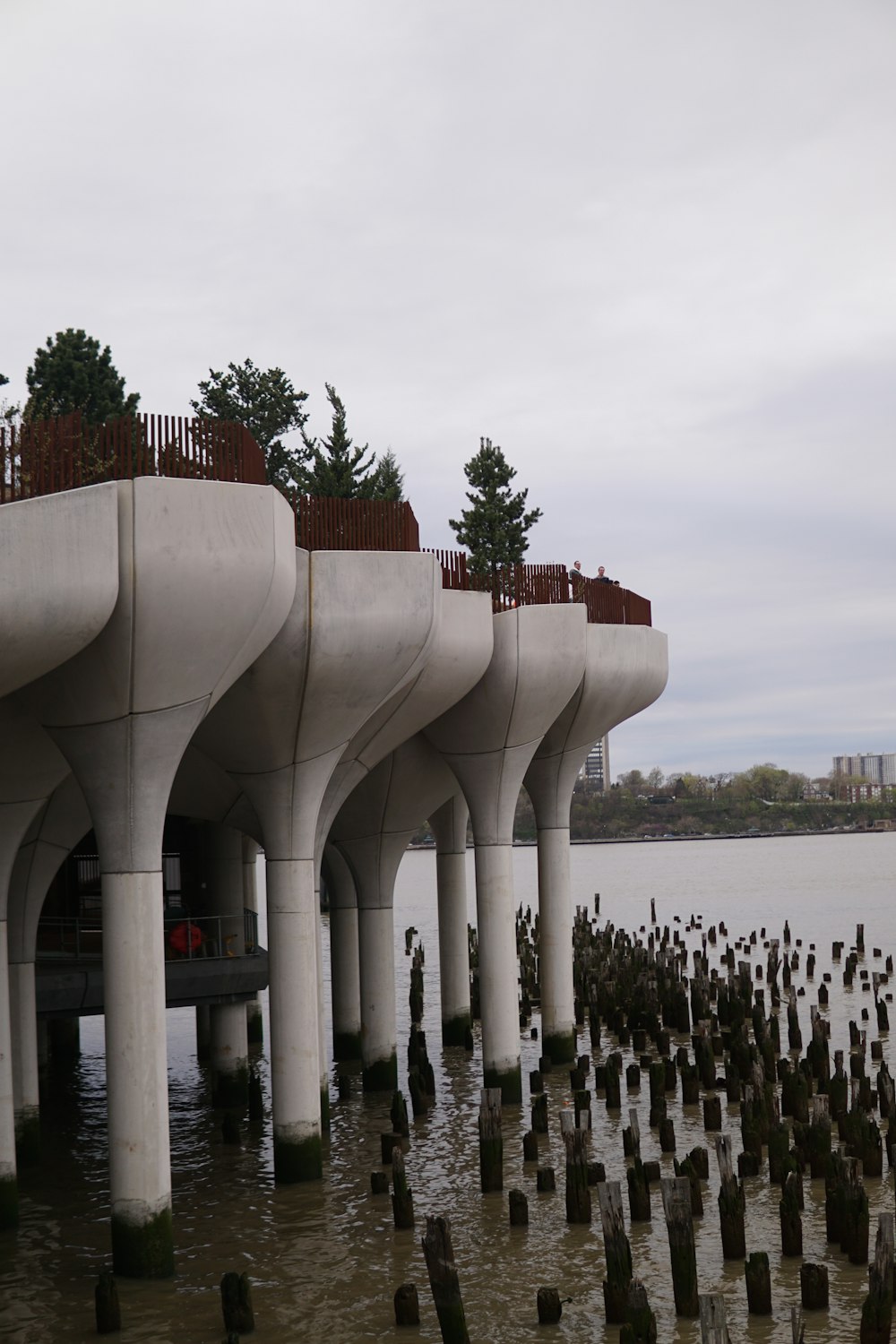 a large white structure with pillars in a body of water