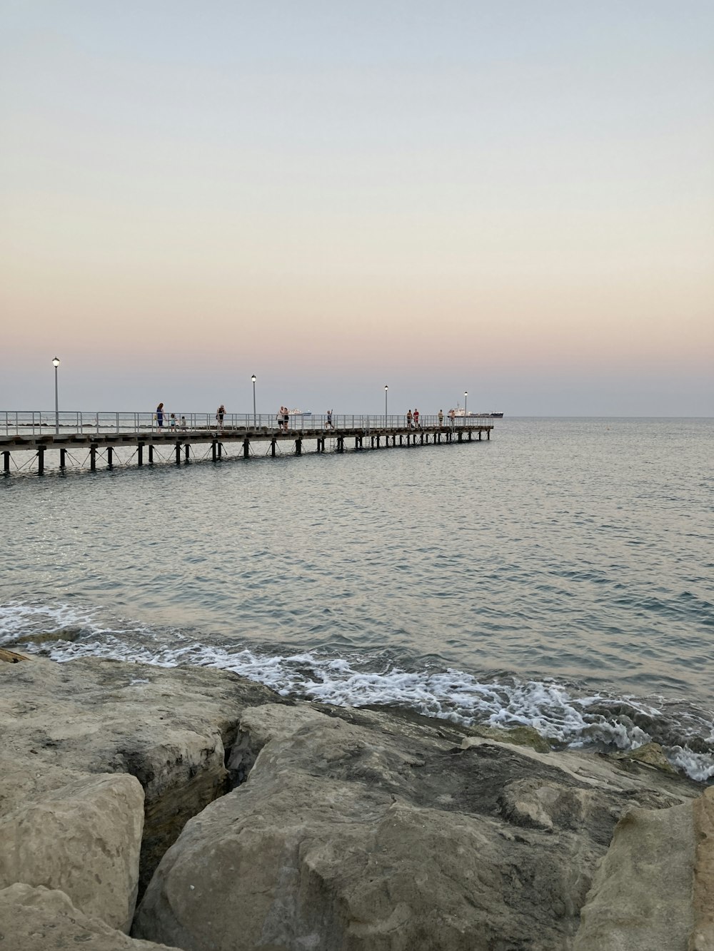 a pier with people walking on it