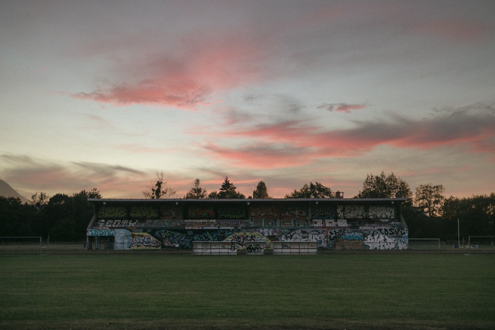 a large green field with graffiti