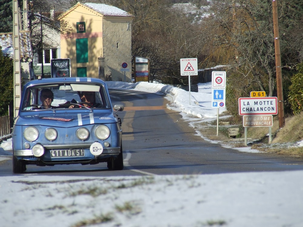 a blue car on a road