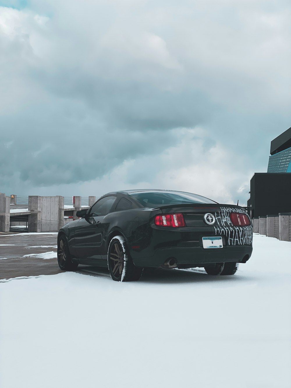 a black sports car parked in the snow