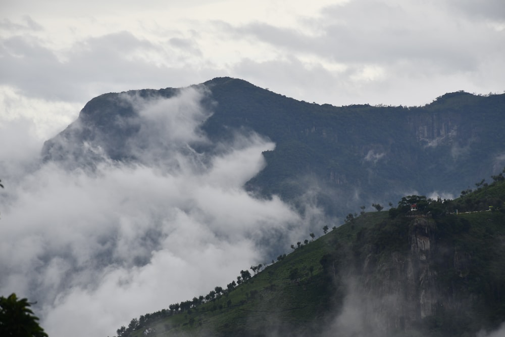 a large mountain with clouds