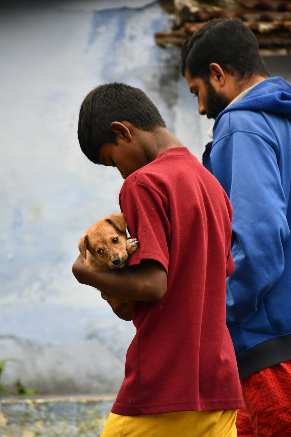 a couple of men holding a dog