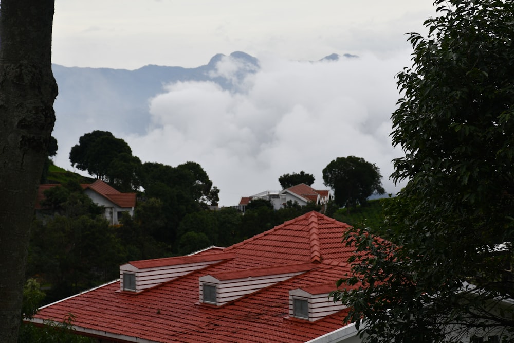 a roof with trees and clouds in the background