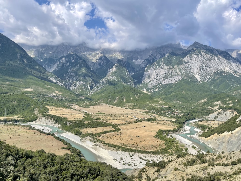 a river running through a valley between mountains