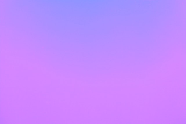 Full-screen gradient background from deep navy to gold with animated code particles swirling gently.