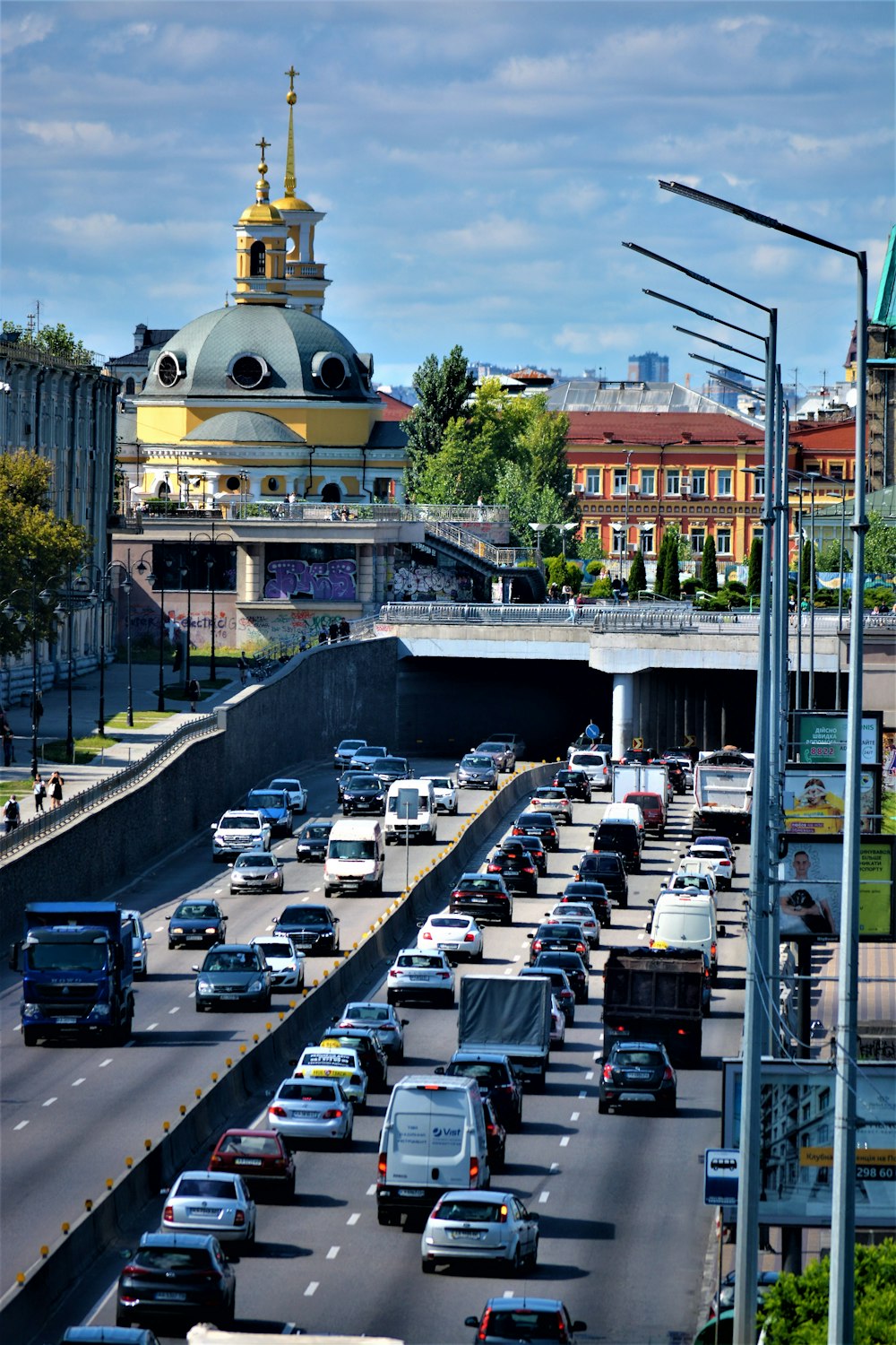 a busy street with cars and a domed building in the background