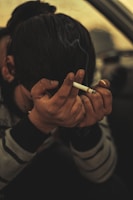 a person holding a cigarette