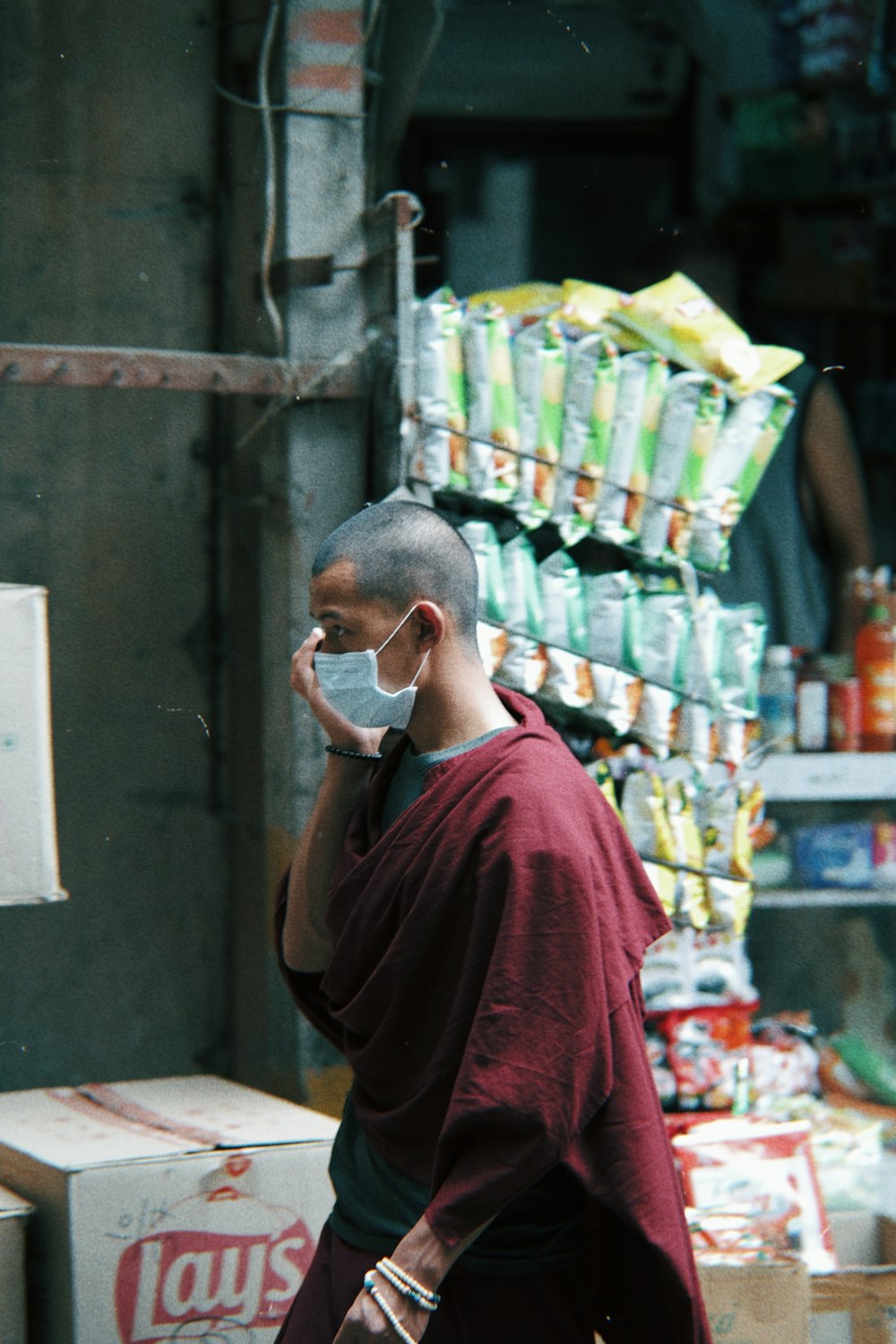 a man with a mask on his face in a store