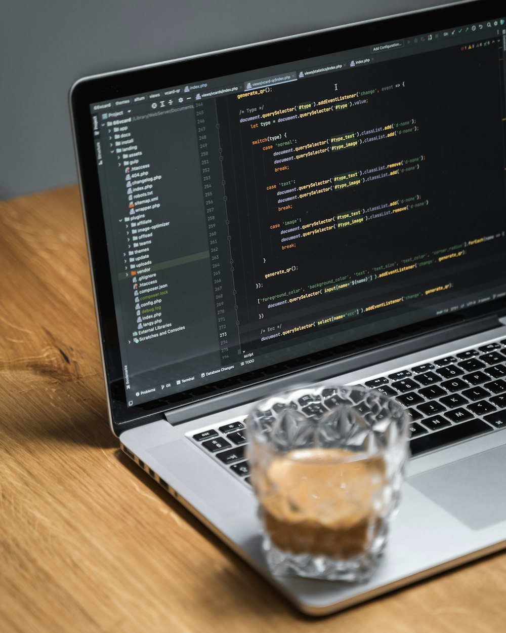 a laptop with a cup of coffee in front of it