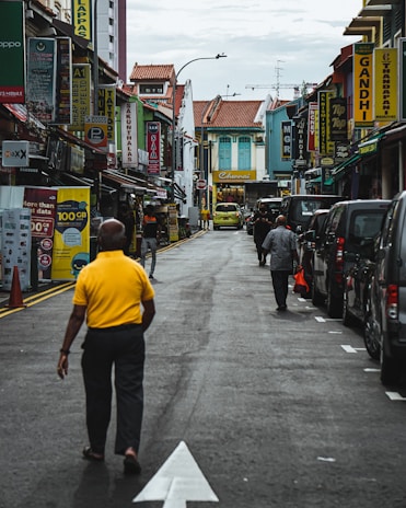 A bustling city street with colorful buildings and happy tourists walking.