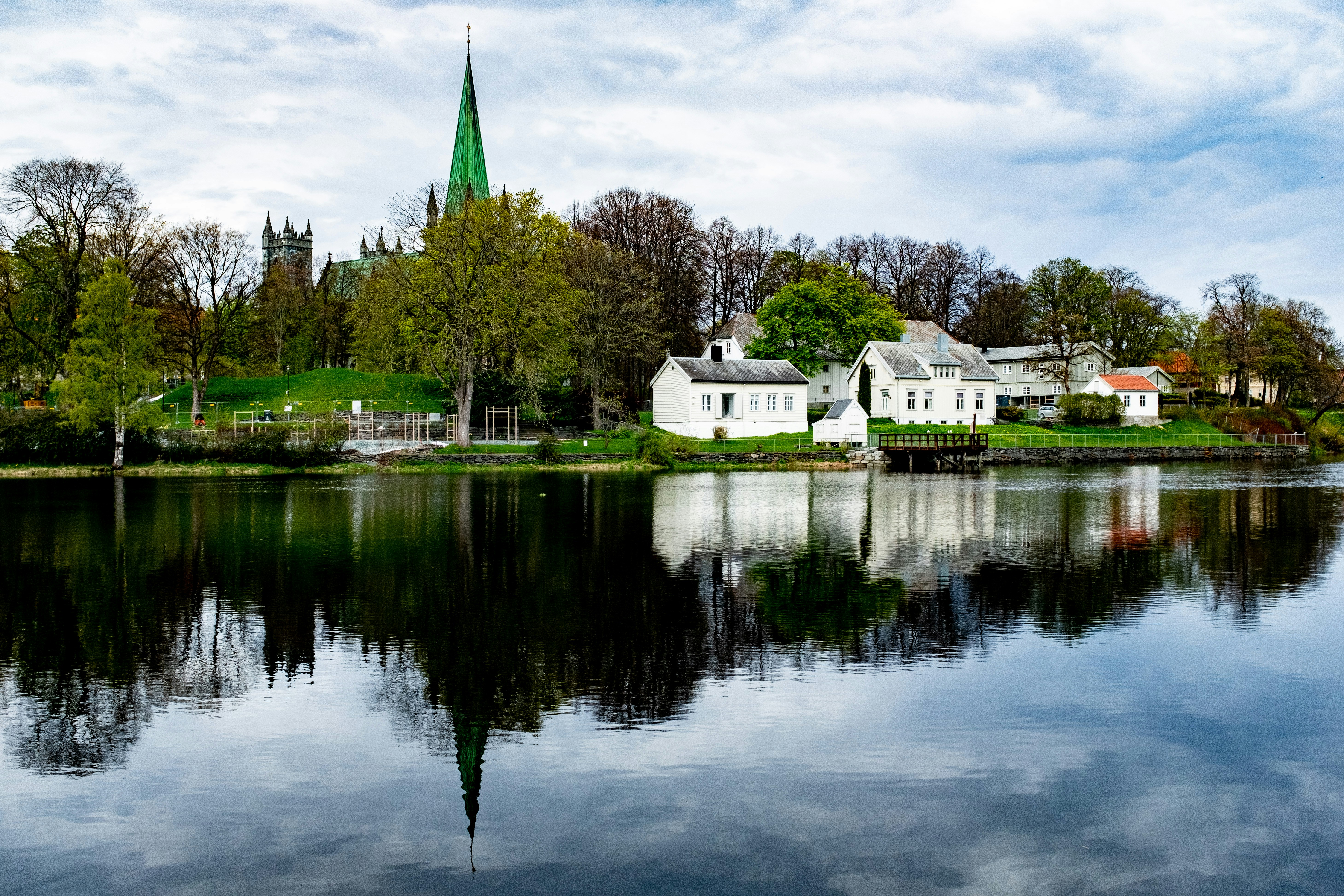 a body of water with buildings and trees around it
