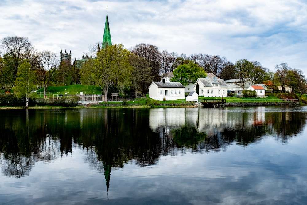 a body of water with buildings and trees around it