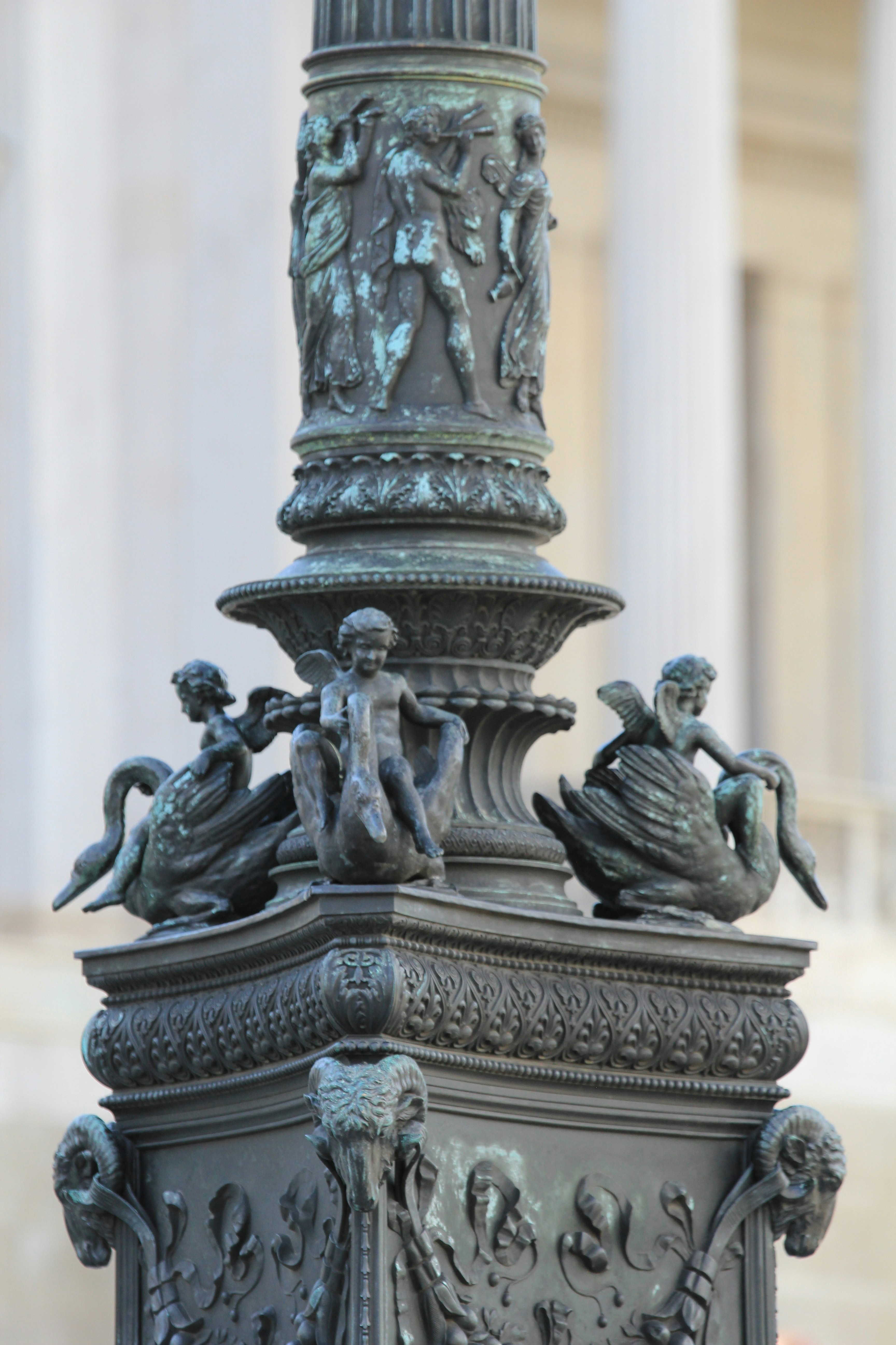 a statue of a man and a woman on a pillar