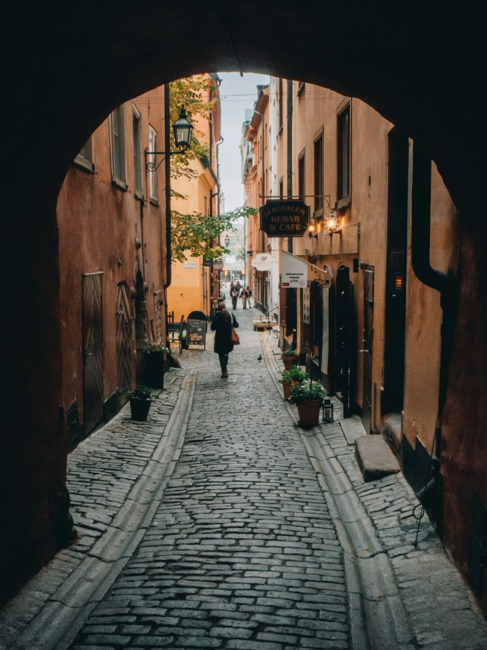 a person walking down a narrow street