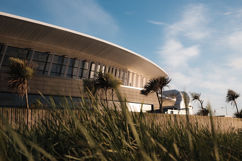 a building with palm trees and grass