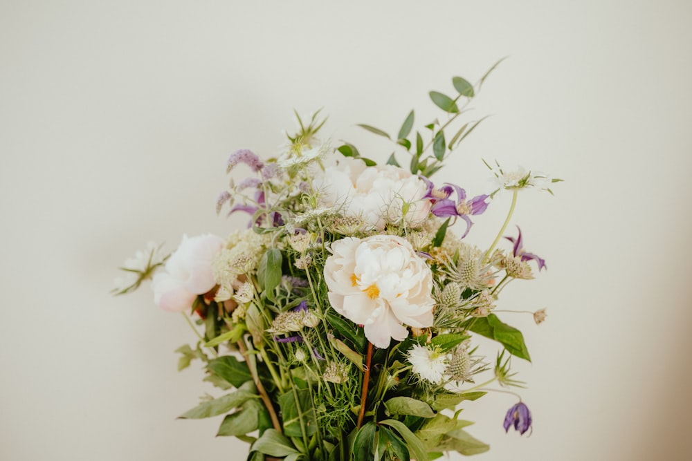 a bouquet of white and purple flowers