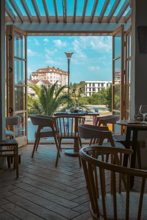 a patio with tables and chairs