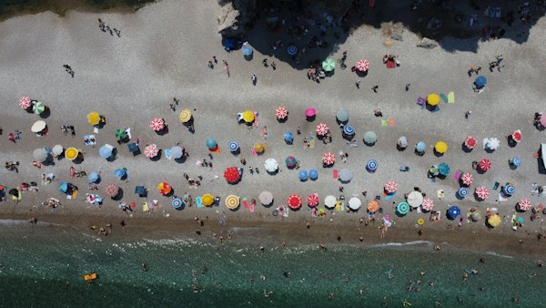 Parasols in rows on the pebble beach at Çıralı, seen from above