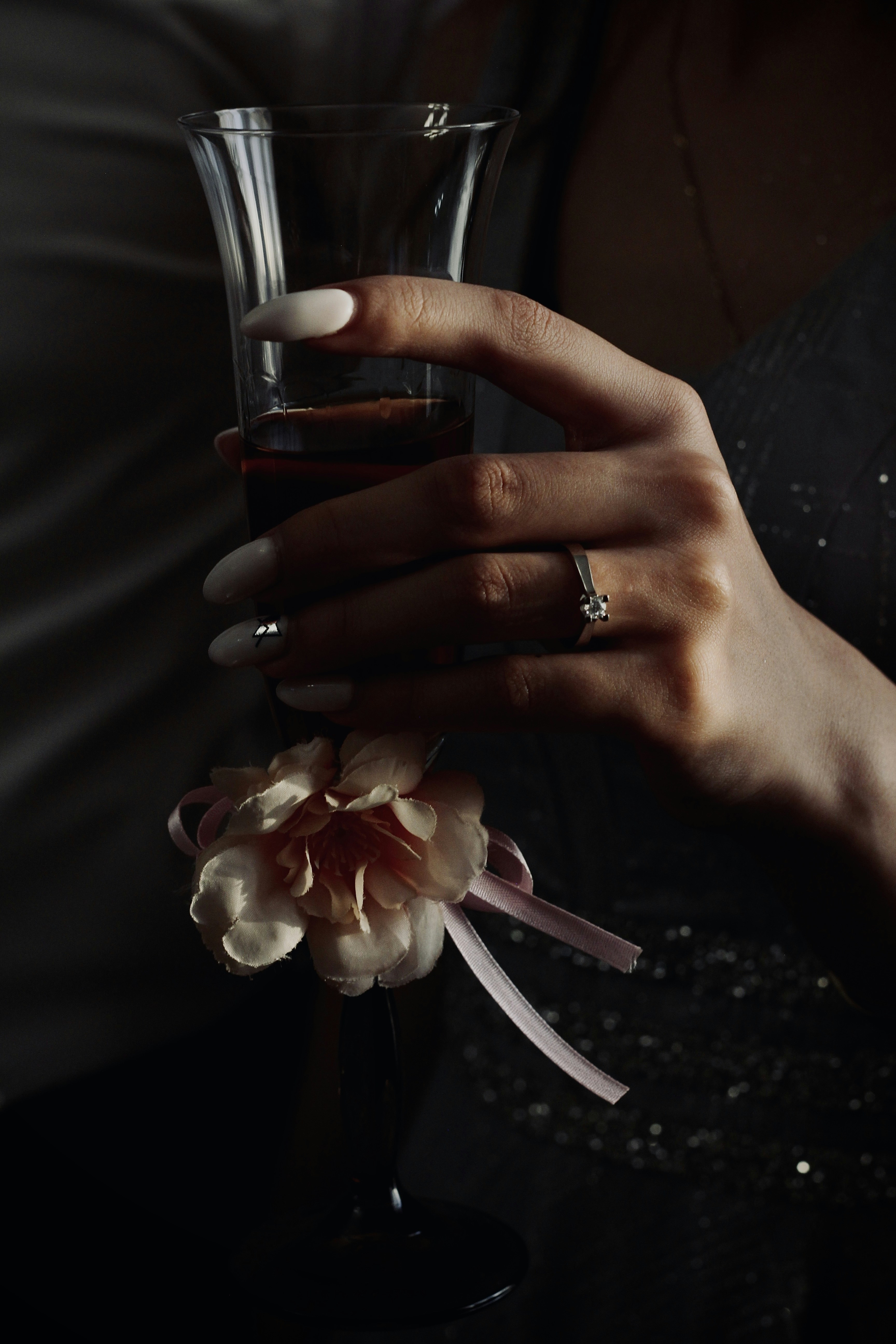 a hand holding a glass of wine