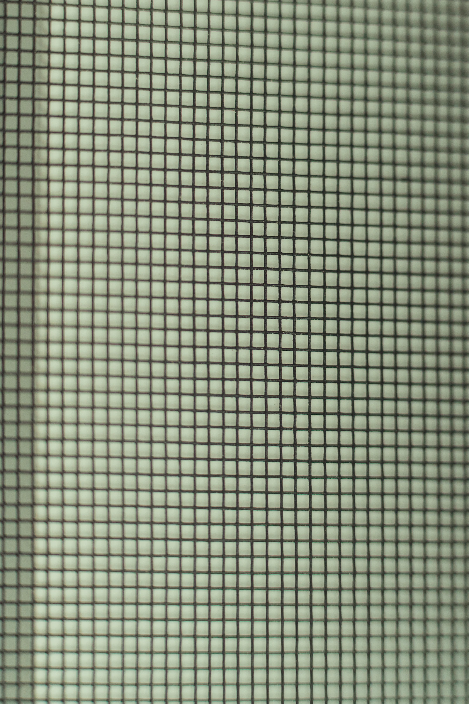 Close-up of charcoal window screen mesh weave like the fiberglass screens rebuilt for Glendora California homes