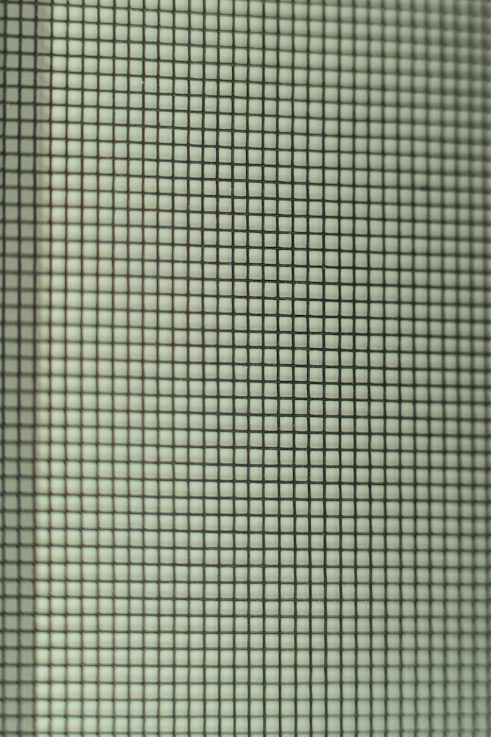 Close-up of charcoal window screen mesh weave
