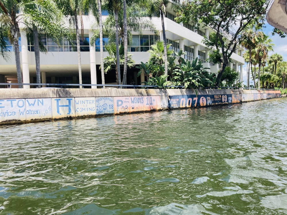 a body of water with a building in the background