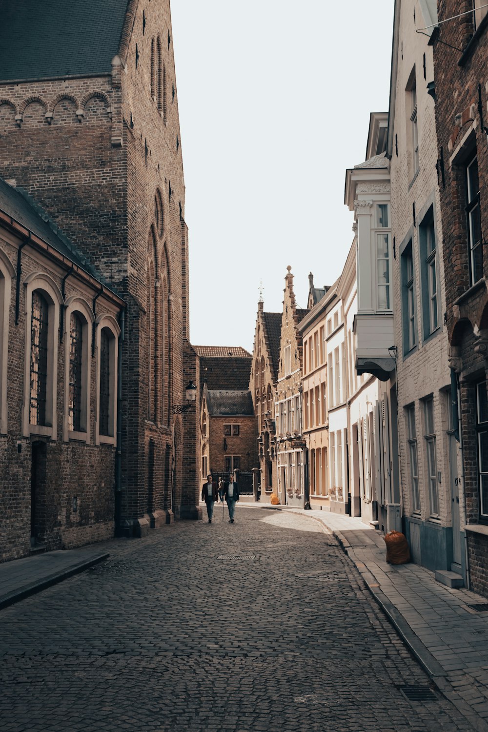 a cobblestone street between buildings