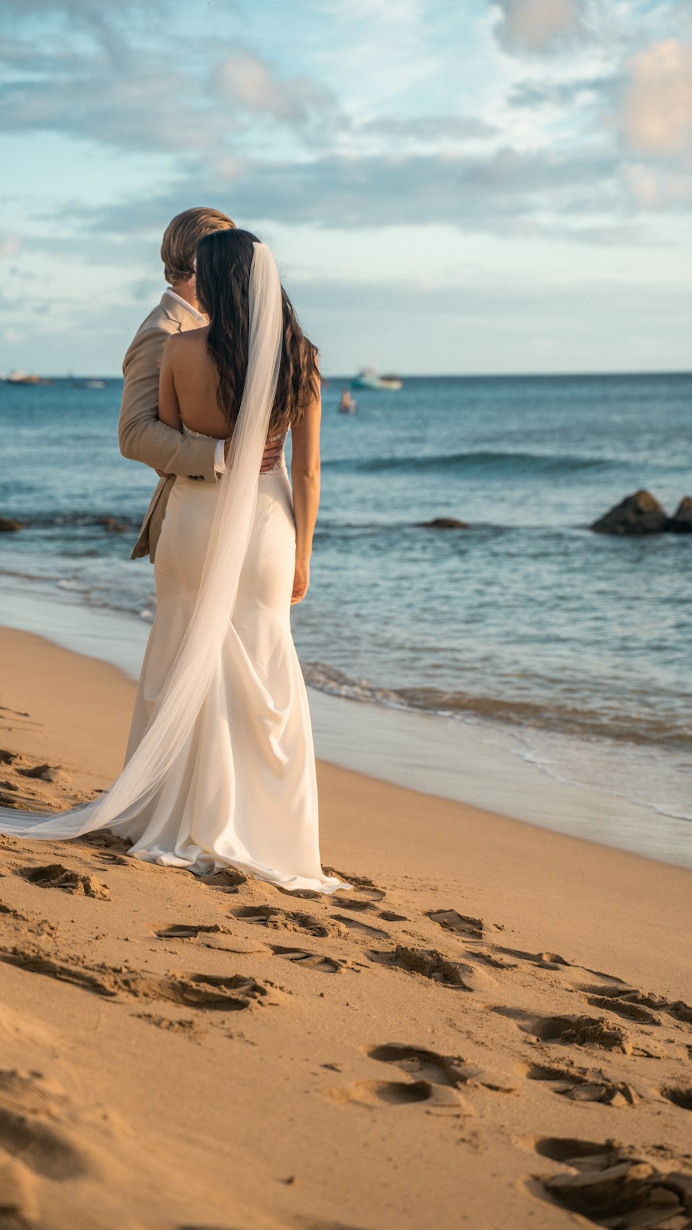 a woman in a white dress on a beach