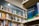 A bookshelf filled with a variety of books, primarily in English. The visible sign above the shelf indicates these are books in English, and several shelves are labeled with alphabetical markers. A large dictionary is prominently displayed, suggesting a focus on English language resources.