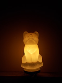 3D crystal portrait of a smiling child holding a pet, illuminated from below.