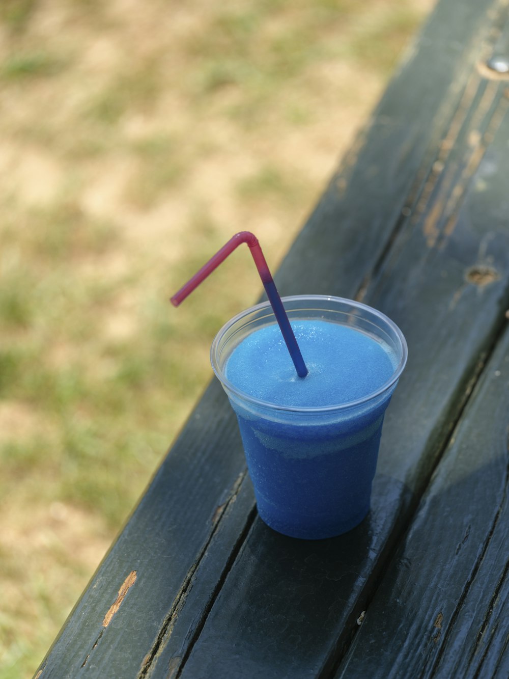 a plastic cup with a straw