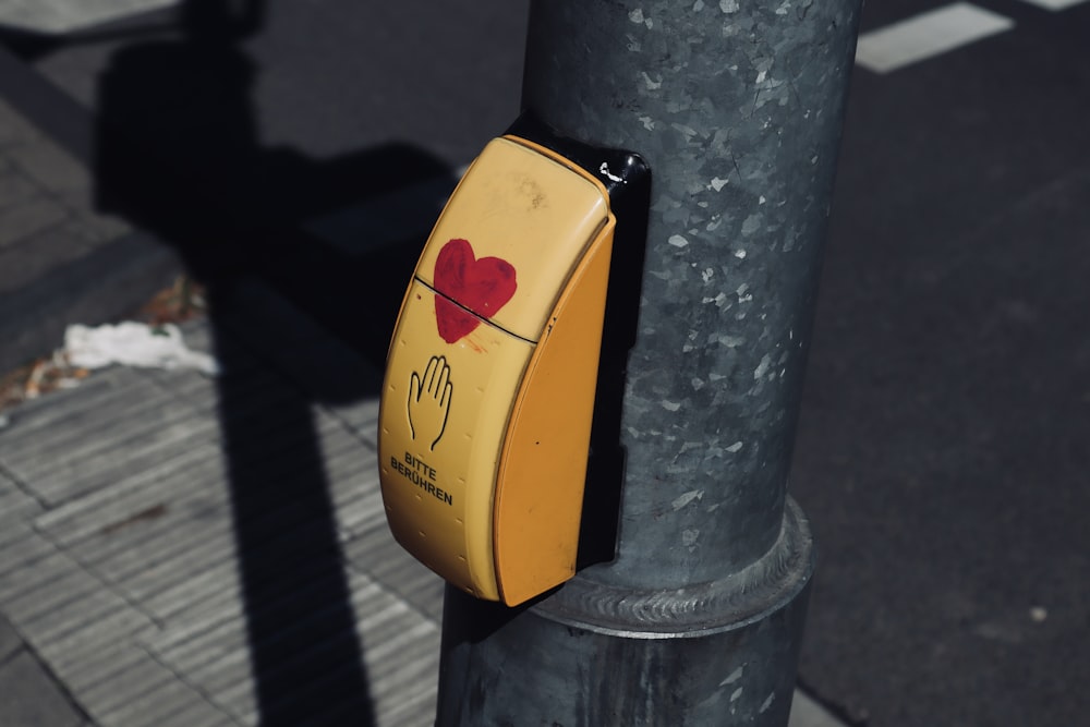 a yellow and black box on a pole