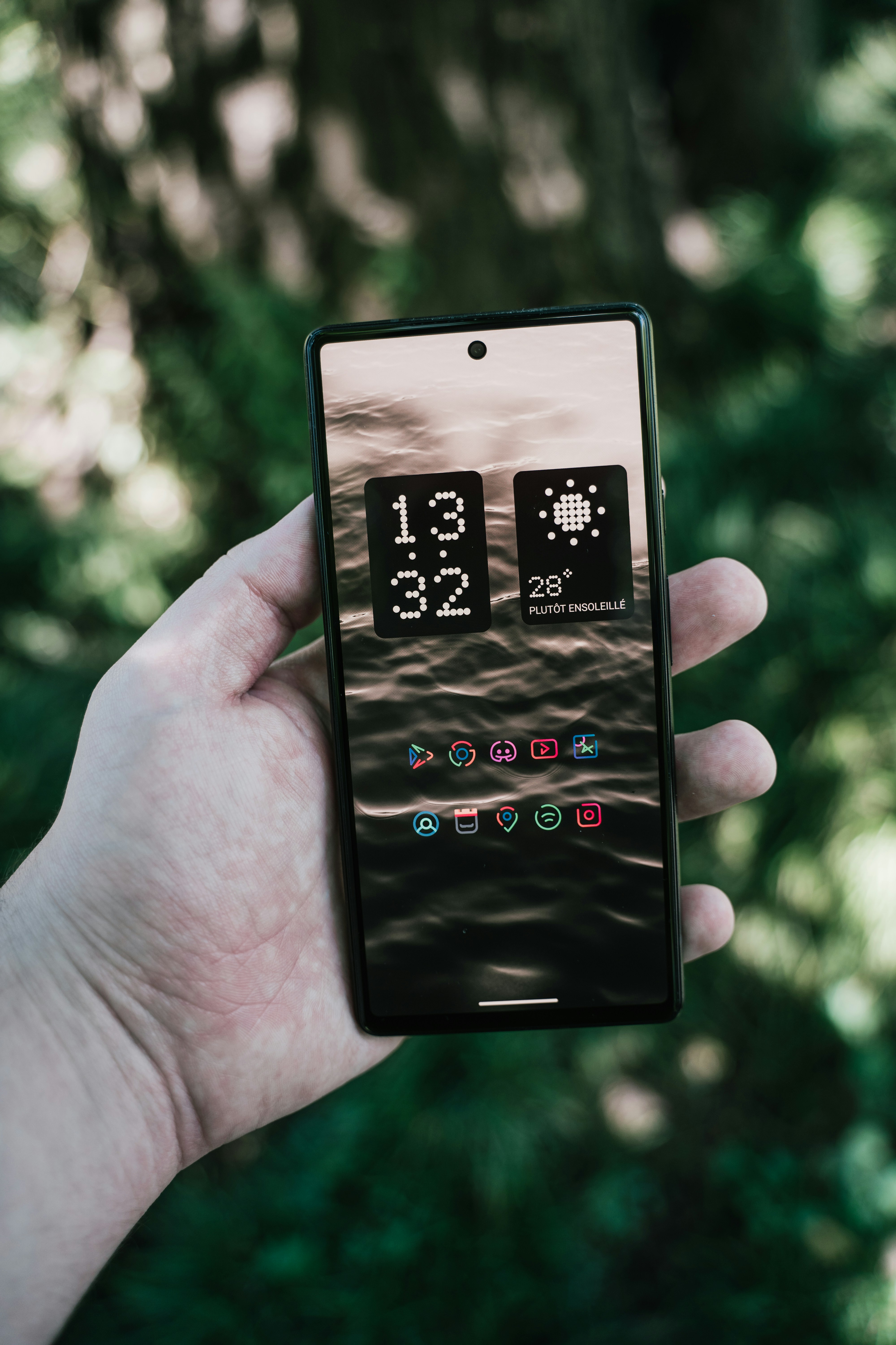 a hand holding a smart phone