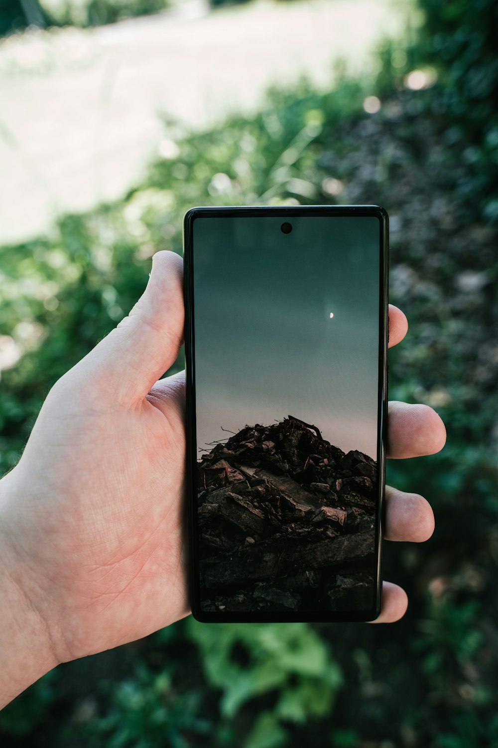 a hand holding a cell phone