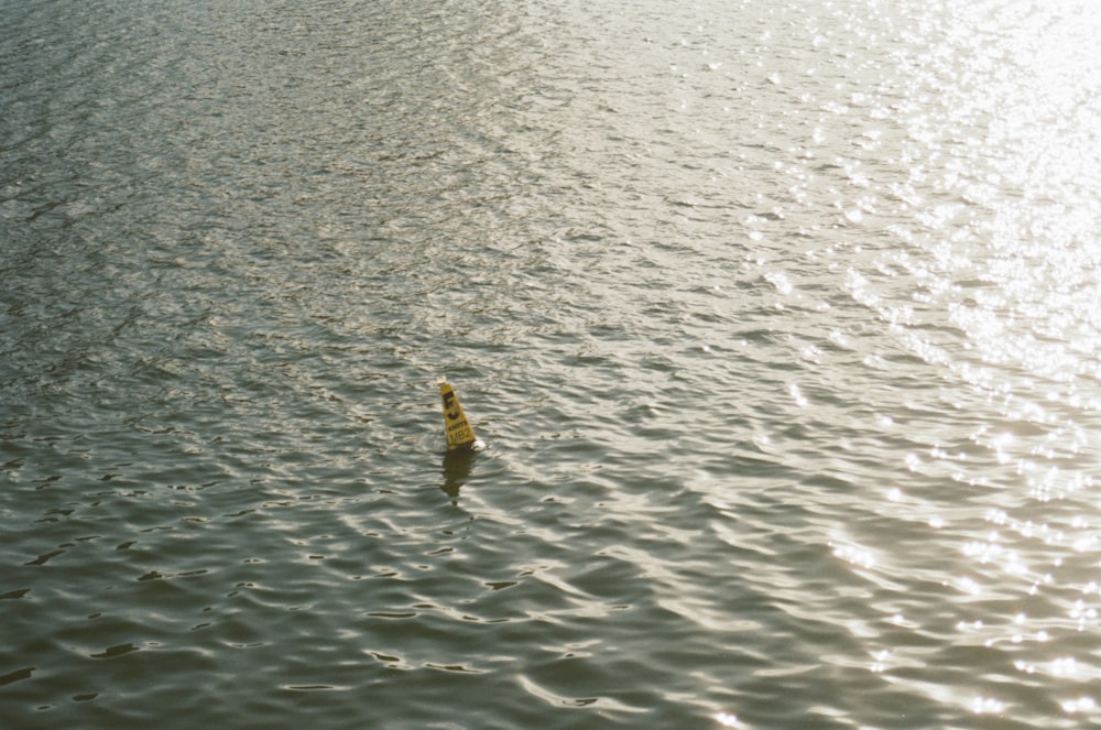 a yellow object floating in water