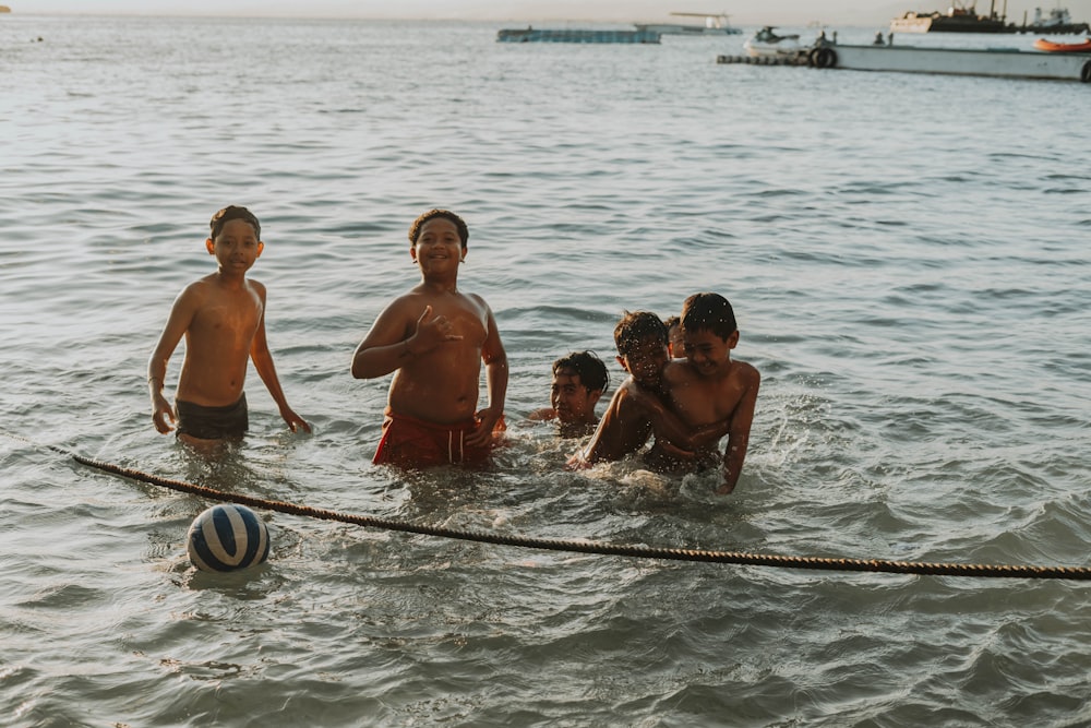 a group of boys playing in the water