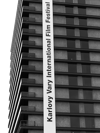 Film festival submission forms and entry tickets on a desk with a laptop showing a spreadsheet