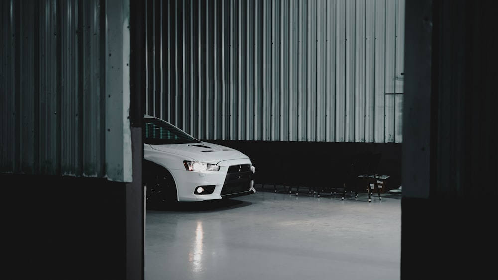 a white sports car parked in a garage