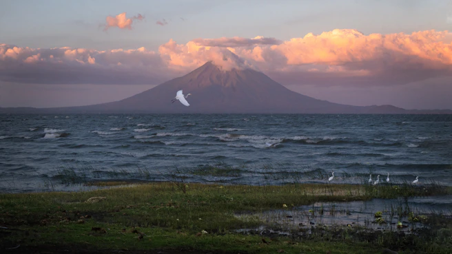 a body of water with a mountain in the background