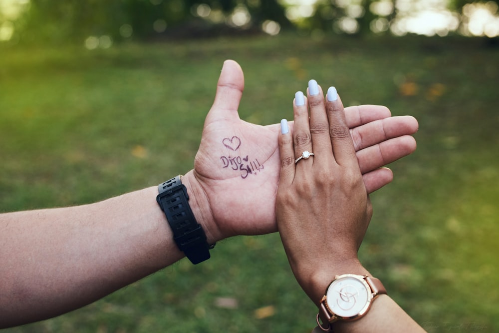 a pair of hands with tattoos