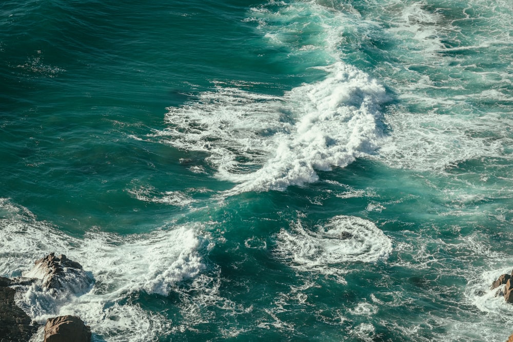 a man riding a wave on top of a body of water