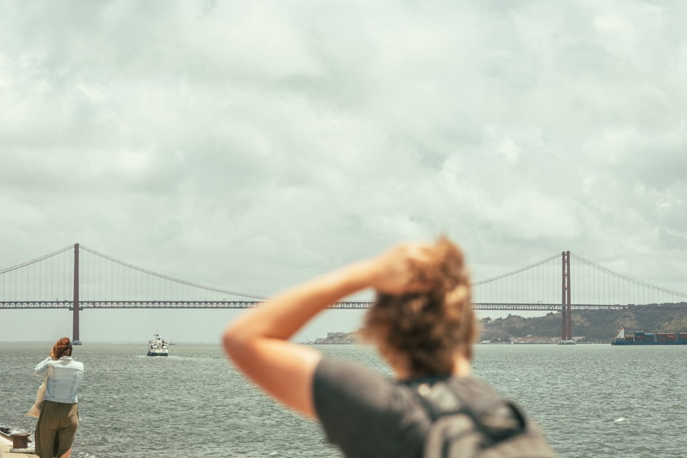 a person taking a picture of a bridge