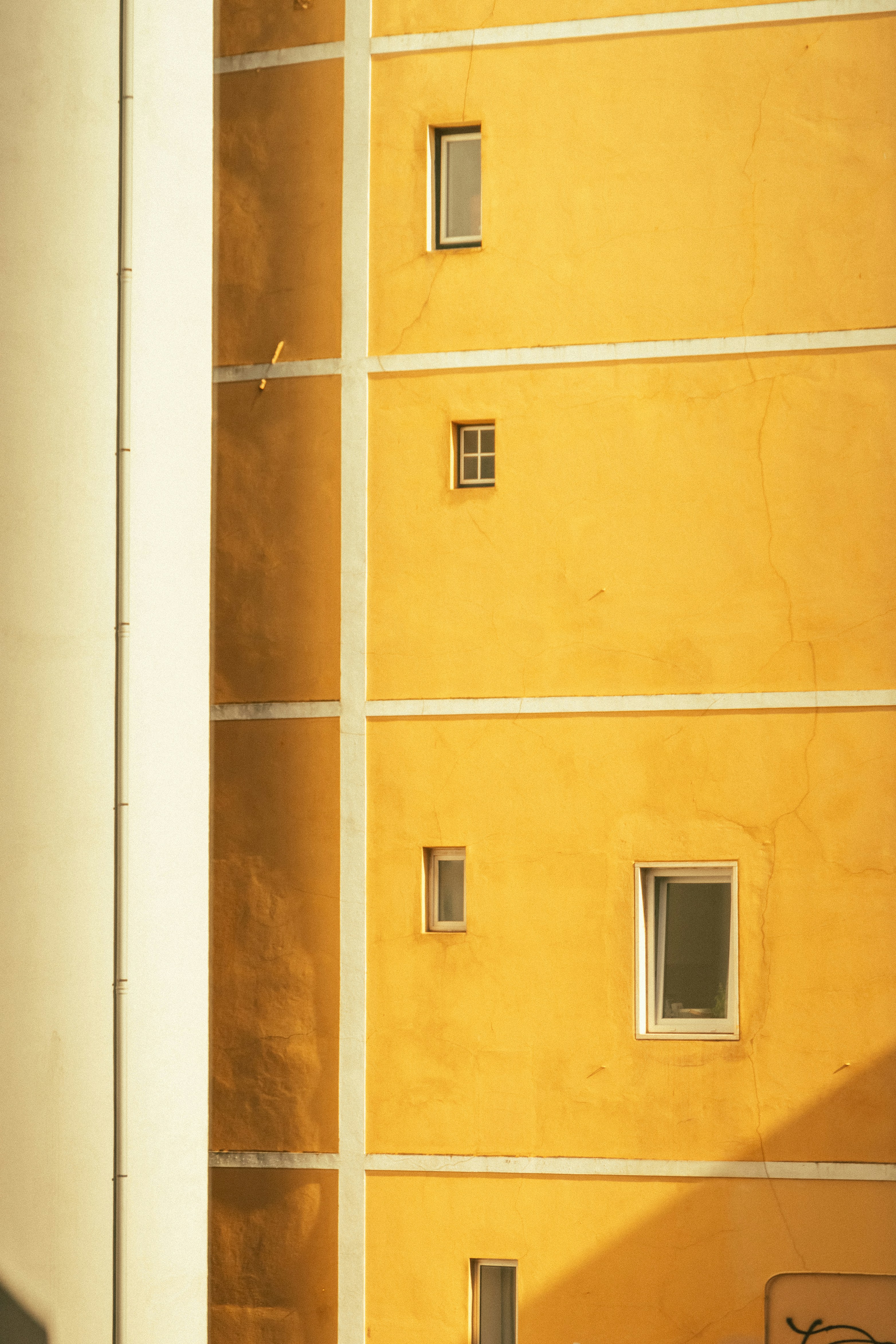 a yellow building with windows