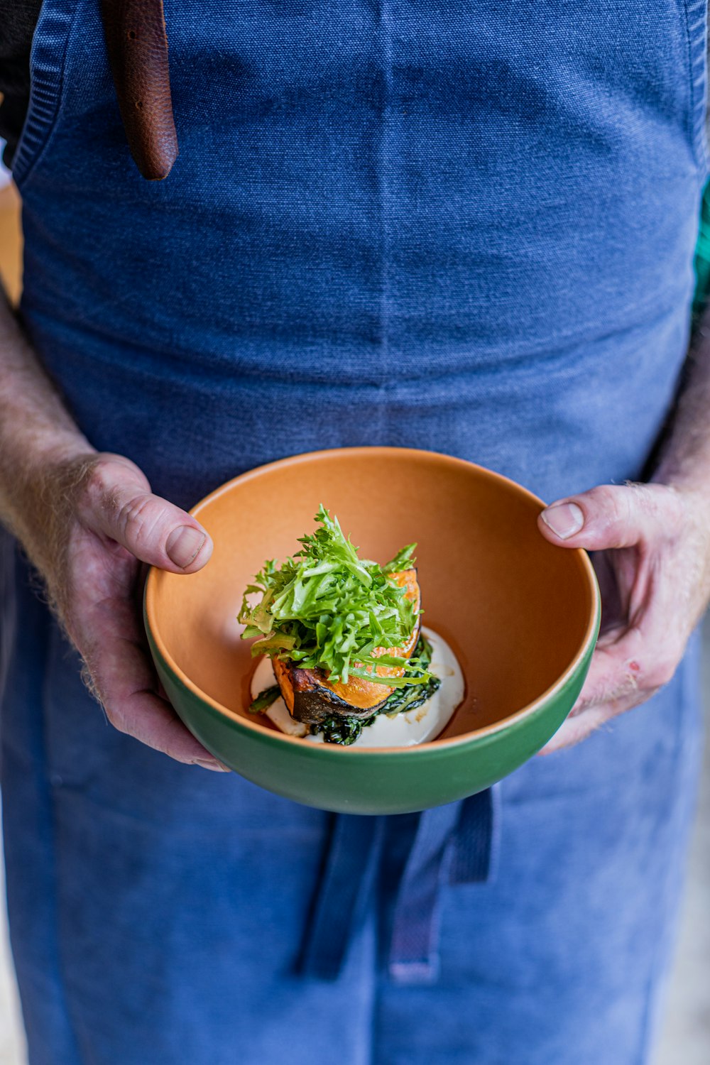 a person holding a bowl of food