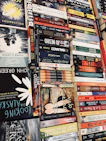 An array of awarded books displayed on a wooden table, representing diverse voices.