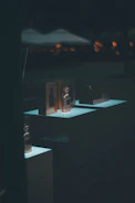 Stylish modern clothing displayed alongside perfume bottles in a bright studio setting.