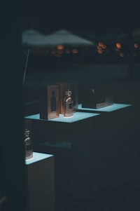 An elegant display of luxury perfume bottles glistening in soft light.